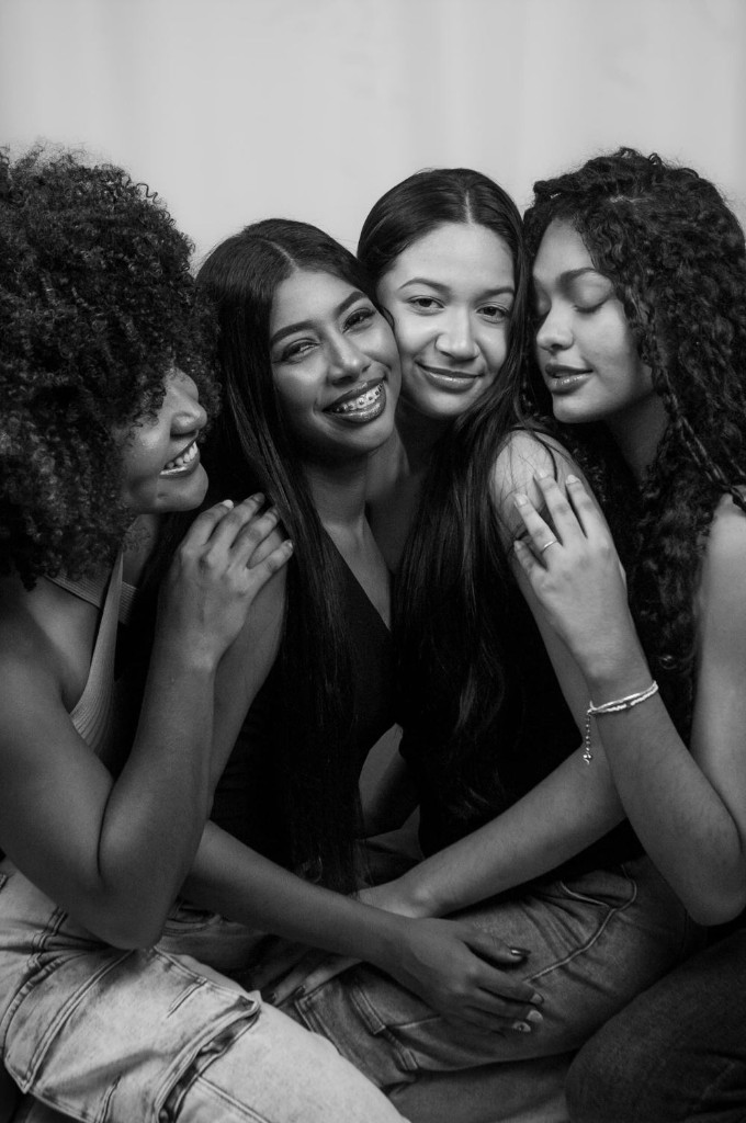 A supportive group of women embracing and smiling