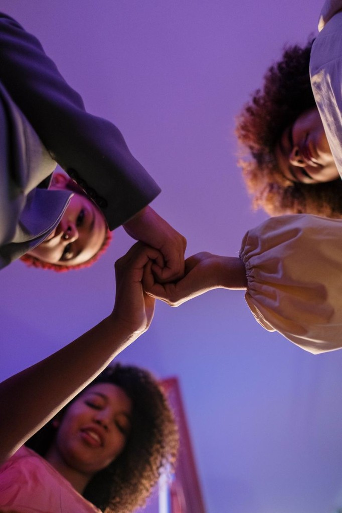 Multiple hands joined together in solidarity